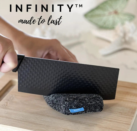 Person cutting Infinity Sponge Odor Resistant And Heat Resistant Silver Fiber Kitchen Cleaning Tool with a knife