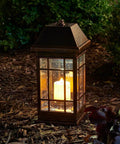 San Rafael II Solar Mission Lantern With Dual High Performance Warm White LEDs And Amber Pillar Accent in garden at night