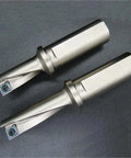 Two silver steel single-edge U-drill bits with carbide inserts and blue screws.