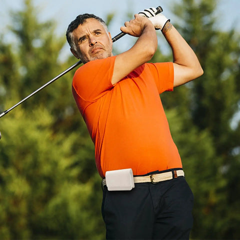 Golfer with Durable PU Leather Golf Rangefinder Case with Belt Clip on waist, swinging club, trees in background