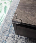 Clear corner protector installed on wood, part of 12 pack, food-grade silicone, for baby proofing edges, tables, safe kid proofing bumpers.