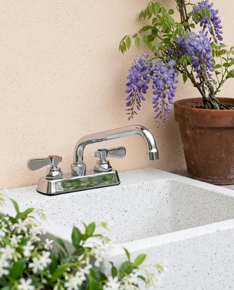 Lead-Free 4 Inch Deck Mount Commercial Kitchen Sink Faucet 8" Swivel Spout with chrome finish above a white sink.