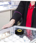 Compact Electric Rotating Turntable Stand For Jewelry Display in a store, showcasing a ring with a 360-degree silent base.