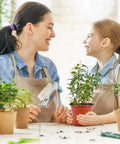Mother and daughter gardening with 4 Inch Plastic Nursery Pots 100 Pack With Drainage Holes Ideal For Seedlings Cuttings And Transplanting