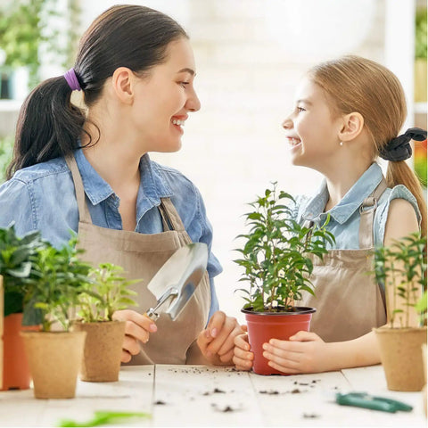 Mother and daughter gardening with 4 Inch Plastic Nursery Pots 100 Pack With Drainage Holes Ideal For Seedlings Cuttings And Transplanting