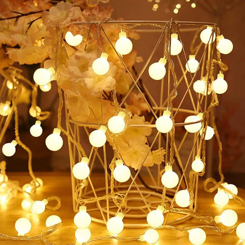 52 Foot Battery Operated String Lights 2 Pack With 120 LEDs illuminating a wire basket and flowers indoors