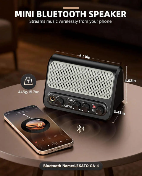 Portable 10W Bluetooth Guitar Amp With Built In Drum Machine Featuring 30 Patterns Clean And Drive Channel Reverb Rechargeable Battery Ultra Compact Practice Amp For Home Studio Or On The Go Jams with smartphone on table