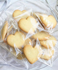 Heart-shaped cookies in clear self-sealing cellophane bags 4x6 inches 200 pcs resealable bags for cookies candy and treats packaging.