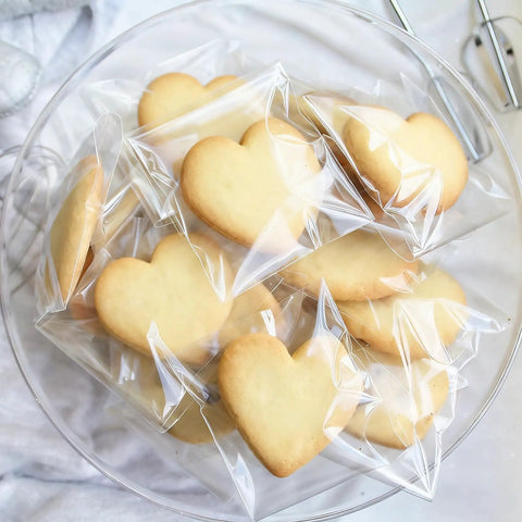 Heart-shaped cookies in clear self-sealing cellophane bags 4x6 inches 200 pcs resealable bags for cookies candy and treats packaging.