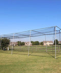 Heavy Duty Twisted Poly Baseball And Softball Batting Cage Net 30 By 12 By 10 Feet Multicolor Practice Net Built Tough With Sag Resistant Top Ropes And Overlapping Door installed in a field.