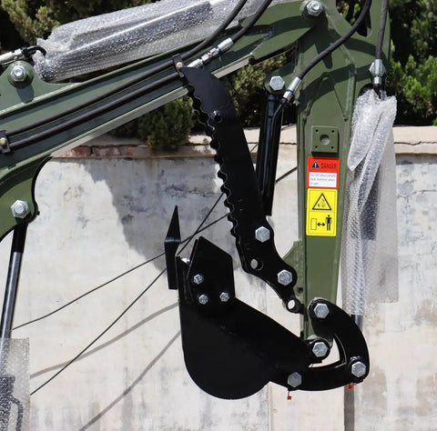 Close-up of Storm X Terror Mini Excavator 1 Ton Trench Digger arm and bucket attachment outdoors.