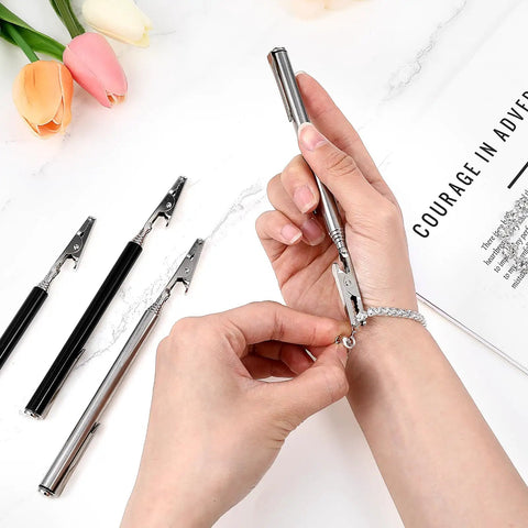 Close-up of Stainless Steel Alligator Clips Set With Telescopic Wire Clamps And Pen Clip used for jewelry making on wrist