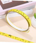 Peel And Stick Measuring Tape Ruler With Double Scale Metric And Imperial Marks Solid For Router Tables And Craft Tasks Clear Numbers That Get The Job Done Quick Pack Of Three Forty Inch Adhesive Strips, measuring tape on a flat surface.