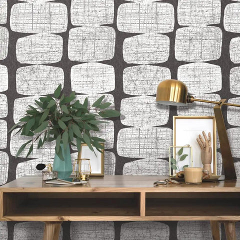 Mid Century Beads Peel And Stick Wallpaper In Black And White on wall behind wooden desk with lamp and plant