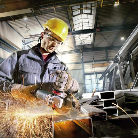 Worker using 6 Inch Angle Grinder With 13.5 Amp Power, 9,600 RPM, cutting through metal in industrial setting with safety gear.