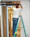 Person applying Pro-Grade Pre-Taped Masking Paper With Built-In Painter Tape 20 Inch Wide By 90 Feet Long 2 Pack for home painting