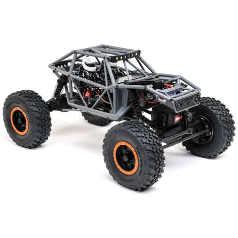 Capra UTB18 One Eighteenth Scale RC Crawler 4WD RTR with multicolor gray tube chassis and portal axles, rear view.
