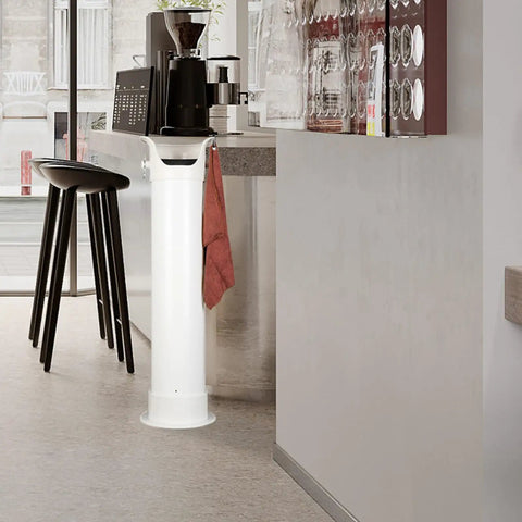 Heavy Duty White Coffee Knock Box And Espresso Dump Bin Featuring Shock Absorbent Base For Fast Grinder Cleanup Removable Liners in a café setting.