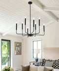 8-Light Modern Black Farmhouse Chandelier With Industrial Metal Arms And Candle-Style Cups in a living room setting