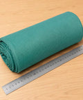 Heavy Duty Polyester Ground Cover Mat With Built Like A Tank Weed Barrier And Water Permeable Drainage Design For Outdoor Landscaping Playground Surface Base Foundation Underlayment rolled with ruler for size reference.