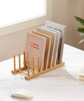 2 Pack Premium Bamboo Dish Rack And Plate Holder With 7 Slots To Level Up Your Kitchen Game solid wood stand holding books on countertop.