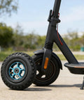 Electric scooter featuring an offroad electric skateboard wheel 200x50 with pneumatic tire and aluminum alloy hub, mounted on front.