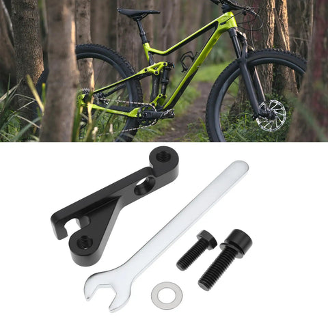 IS Mount To Flat Mount Brake Adapter For 160mm Rear Or 180mm Front Rotors with tools and mountain bike in background