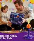 Talking Astronomy Solar System Model Kit For Kids With Immersive Projector, Exhibits 8 Planets Orbiting The Sun On Any Surface, STEM Toy For 5 Plus Year-Olds, Hands-On Space Science Learning, Turns Ceilings Into A Planetarium. Father and son holding boxed solar system toy at a birthday party.