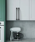 10 Pack 7 Inch Matte Black Cabinet Handles With 177mm Hole Centers on white kitchen cupboards above countertop with mixer.