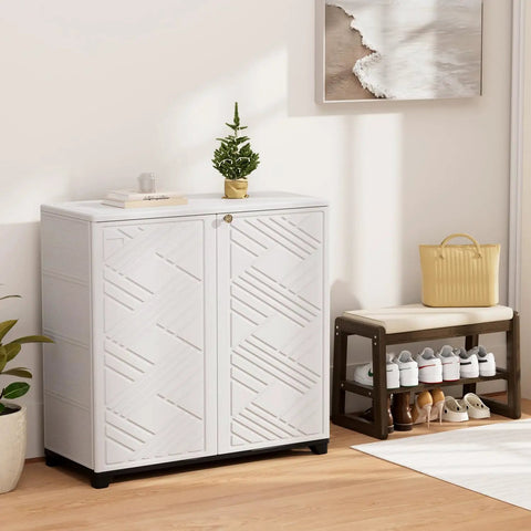 White waterproof outdoor storage cabinet with two doors and decorative design, placed indoors, showing resin material and compact size.
