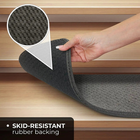 Close-up of gray skid resistant carpet stair tread with non-slip rubber backing, showing hand lifting corner