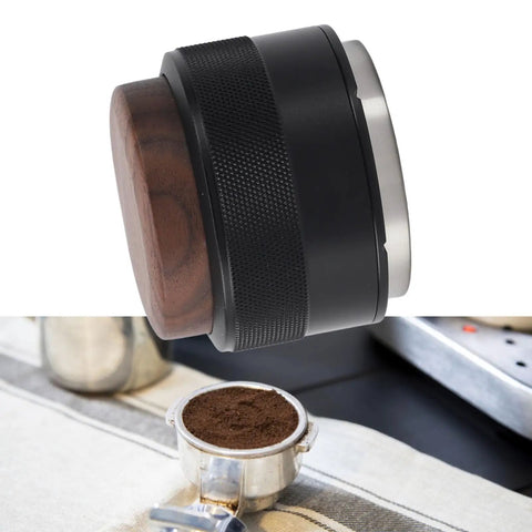 Top Tier 51Mm Black Coffee Distributor And Espresso Tamper For Baristas Stainless Steel Tool on a table next to coffee grounds.
