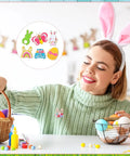 Woman wearing a bunny enamel pin from the Grab These Fresh Forty Piece Easter Enamel Pins Bulk Collection while decorating eggs.