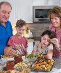 Family enjoying chips and dips in a modern kitchen setting, featuring a rustic wooden countertop and warm lighting.