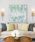 Living room with Sleek Modern Wall Sconces in Antique Brass Brush Finish With White Fabric Shade on either side of wall art