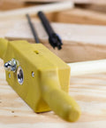 Close-up of Plastic Dowel Thread Tap Kit For Woodworking Three Quarters Inch Dowel Jig Set With Tap Die For Cutting External And Internal Threads Six TPI For Fasteners And Holes on wooden surface
