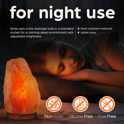 Himalayan Pink Salt Lamp With Real Wood Base Natural Glow Night Light For Relaxation And Energy next to sleeping child.