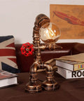 Steampunk Robot Pipe Desk Lamp With Vintage Industrial Edison Lighting, Bronze Metal Finish, Red Valve on table