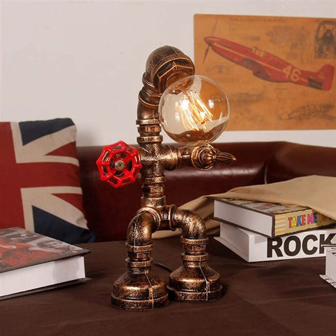 Steampunk Robot Pipe Desk Lamp With Vintage Industrial Edison Lighting, Bronze Metal Finish, Red Valve on table