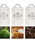 Boost Your Pantry Game With This Three Piece Airtight Kitchen Storage Jar Set Crafted From Thick Powder Coated Iron. Set of 3 jars labeled for tea, sugar, and coffee.