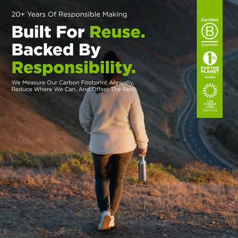 Woman walking outdoors holding a 27 Oz Brushed Stainless Steel Water Bottle With Bamboo Lid Leak Proof Reusable Drinkware.