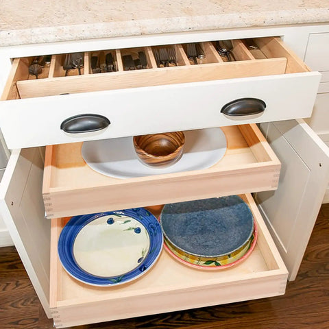 Smooth Glide Pull Out Cabinet Organizer And Slide Out Drawer with contents including plates and utensils in a kitchen drawer.
