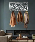 Sleek Abstract Wall Rack - Heavy Duty Modern Metal Hooks - Premium Key Holder And Coat Organizer - Three coats hanging on stylish wall decor.