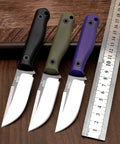 Fixed Blade Knife With G10 Handle For EDC And Outdoor Survival Heavy Duty Camping Hunting Fishing Hiking Emergency Rescue Utility Tool For Everyday Carry And Fruit Cutting in black, green, and purple handles with ruler for scale.