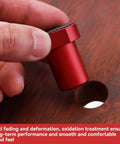 Close-up of a hand placing red aluminum clamp from 12 Piece Aluminum Alloy Bench Dog Clamp Set For MFT Workbenches into a hole