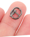 Close-up of a tiny alloy buckle in gunmetal color from 150 Pieces Mini Belt Fasteners Tiny Alloy Buckles For Doll Clothes And Shoes Diy Crafting Mixed Silver Gunmetal Antique Bronze Colors Easy Assembly Miniature Sewing Accessories