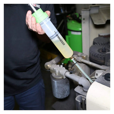 Hand using Compact 200cc Fluid Extractor and Filler Pump for precise fluid transfer in engine bay
