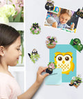 A child placing a magnet from Black Cat Diamond Art Magnets Kit 16Pcs 5D DIY Diamond Painting Magnets on a refrigerator.