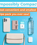 Ultra Compact Travel Flushable Wipes With 99.5 Percent Water And Aloe next to phone, wallet, bottle, and purse.