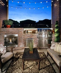Outdoor patio setting with 25 Foot G40 Globe String Lights With 25 LED Bulbs For Indoor And Outdoor Use End To End Connectable above a seating area.
